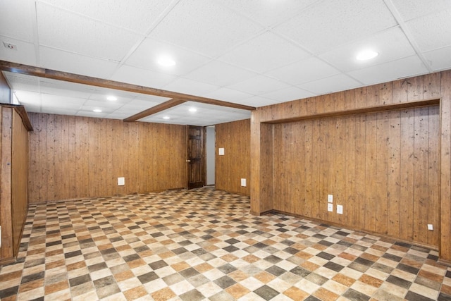 1309 1st St, Minot, ND 58701 - finished below grade area featuring wooden walls, a drop ceiling, recessed lighting, baseboards, and light floors