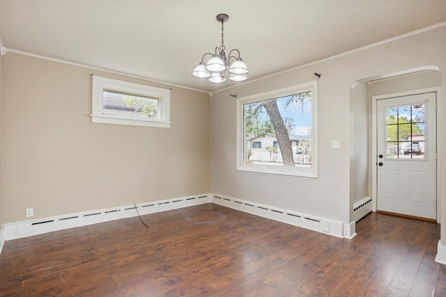 1309 1st St, Minot, ND 58701 - unfurnished dining area featuring crown molding, plenty of natural light, hardwood / wood-style floors, a chandelier, and baseboard heating