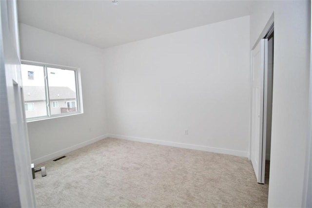 138 Mulberry Loop, Minot, ND 58703 - unfurnished bedroom with carpet floors and baseboards