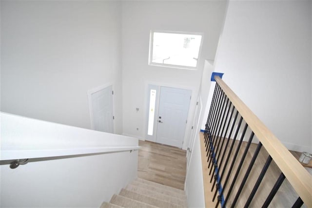 138 Mulberry Loop, Minot, ND 58703 - stairway with wood finished floors, a high ceiling, and baseboards