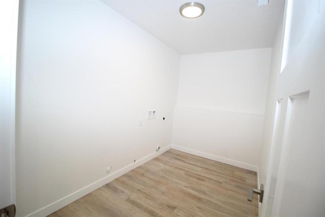 138 Mulberry Loop, Minot, ND 58703 - washroom with baseboards and wood finished floors
