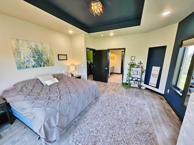 1007 5th St, Rugby, ND 58368 - bedroom featuring wood finished floors, a raised ceiling, and recessed lighting