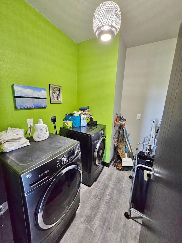 1007 5th St, Rugby, ND 58368 - clothes washing area featuring washer and dryer and wood finished floors
