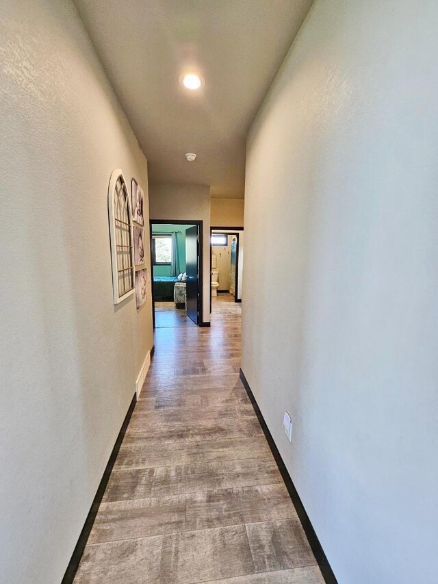 1007 5th St, Rugby, ND 58368 - hall with baseboards, recessed lighting, and wood finished floors