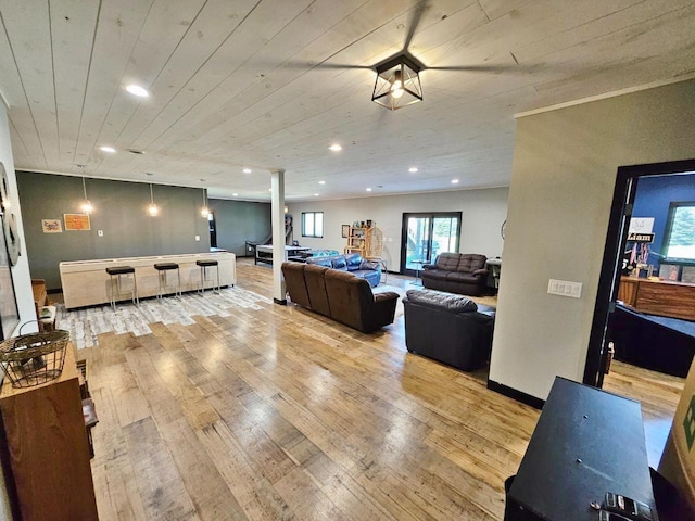 1007 5th St, Rugby, ND 58368 - living area featuring light wood-style floors, ornate columns, wooden ceiling, and recessed lighting