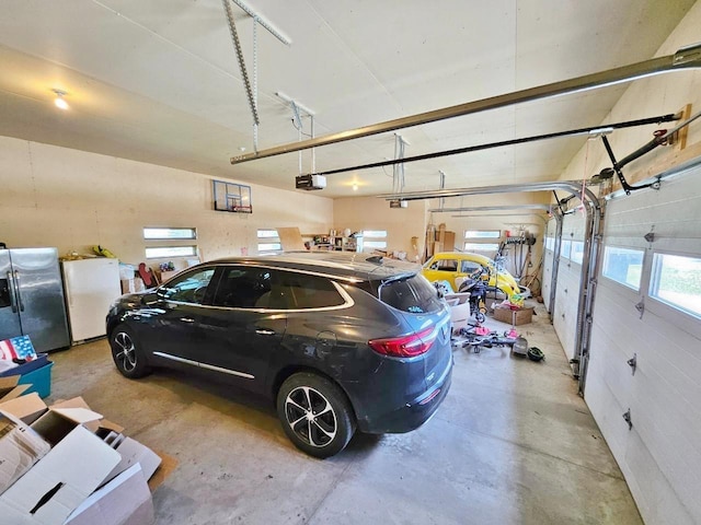 1007 5th St, Rugby, ND 58368 - garage featuring stainless steel fridge with ice dispenser, fridge, and a garage door opener