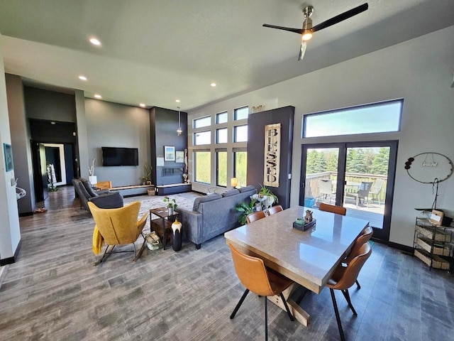 1007 5th St, Rugby, ND 58368 - dining room featuring wood finished floors, a ceiling fan, recessed lighting, baseboards, and a high ceiling