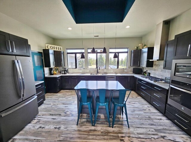 1007 5th St, Rugby, ND 58368 - kitchen with appliances with stainless steel finishes, light wood-style flooring, plenty of natural light, tasteful backsplash, and recessed lighting