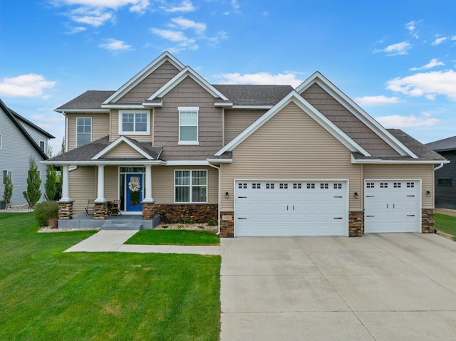 1804 Valley Bluffs Dr, Minot, ND 58701 - craftsman-style home featuring driveway, a front yard, stone siding, and a garage