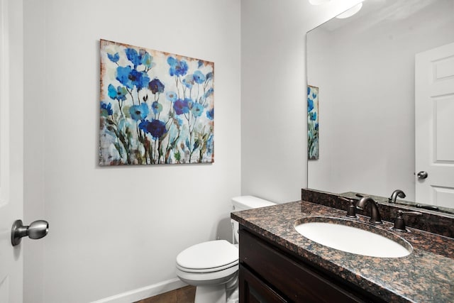 1804 Valley Bluffs Dr, Minot, ND 58701 - half bathroom featuring toilet, vanity, and baseboards