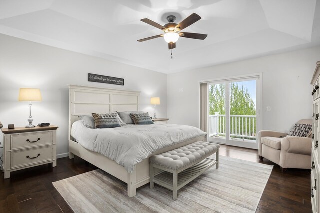 1804 Valley Bluffs Dr, Minot, ND 58701 - bedroom with access to outside, dark wood-style flooring, a raised ceiling, and ceiling fan