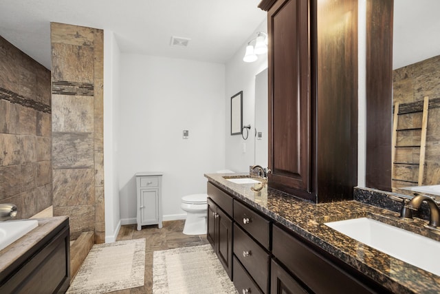 1804 Valley Bluffs Dr, Minot, ND 58701 - full bath with toilet, double vanity, baseboards, a tub to relax in, and tiled shower