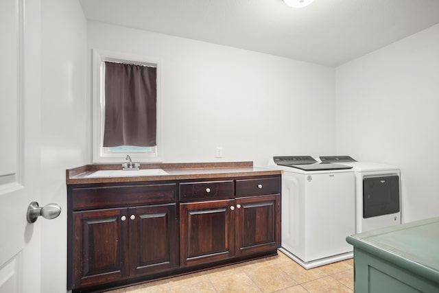 1804 Valley Bluffs Dr, Minot, ND 58701 - laundry area with washer and dryer, cabinet space, and light tile patterned flooring