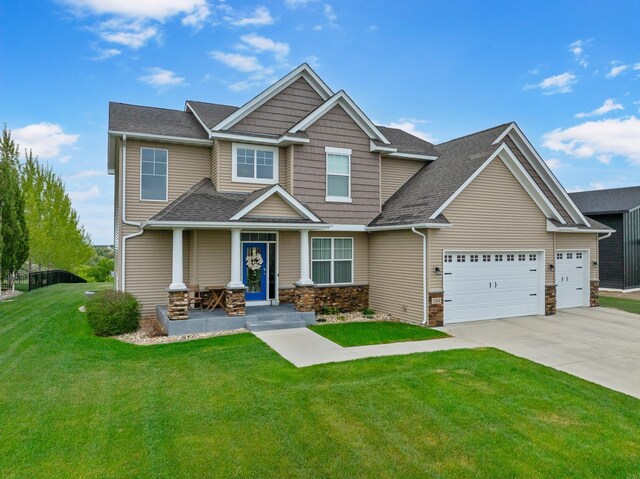 1804 Valley Bluffs Dr, Minot, ND 58701 - craftsman-style house featuring a front yard, a porch, driveway, a garage, and stone siding