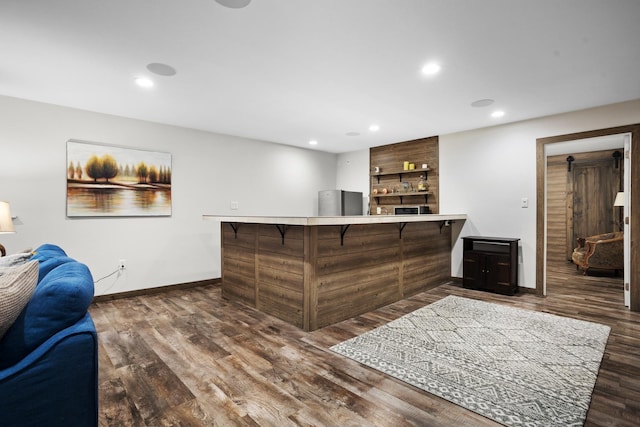 1804 Valley Bluffs Dr, Minot, ND 58701 - bar area featuring baseboards, wood finished floors, recessed lighting, and freestanding refrigerator