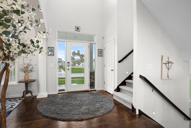 1804 Valley Bluffs Dr, Minot, ND 58701 - entryway featuring a towering ceiling, hardwood / wood-style flooring, stairs, and baseboards