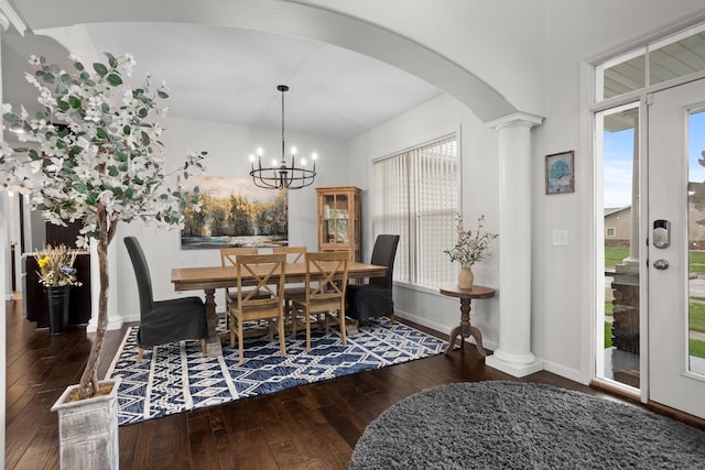 1804 Valley Bluffs Dr, Minot, ND 58701 - dining area with hardwood / wood-style flooring, arched walkways, baseboards, decorative columns, and lofted ceiling