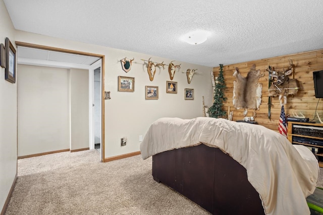 917 17th St Unit 0, Minot, ND 58703 - carpeted bedroom featuring wood walls, baseboards, and a textured ceiling