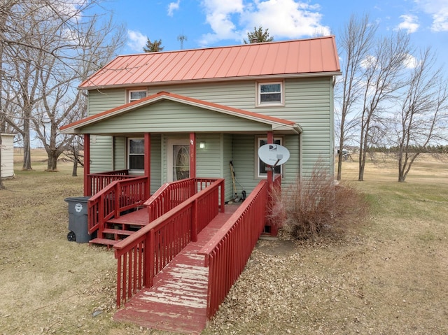 101 Central Ave, Des Lacs, ND 58733 - view of front of house with covered porch, metal roof, and a front yard