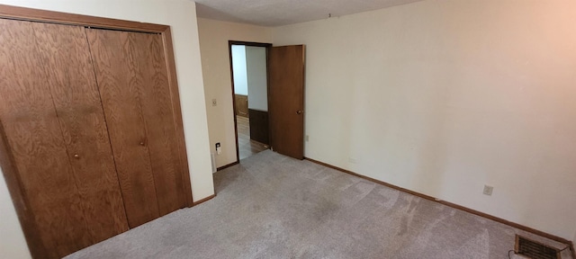101 Central Ave, Des Lacs, ND 58733 - unfurnished bedroom with carpet flooring, baseboards, and a closet