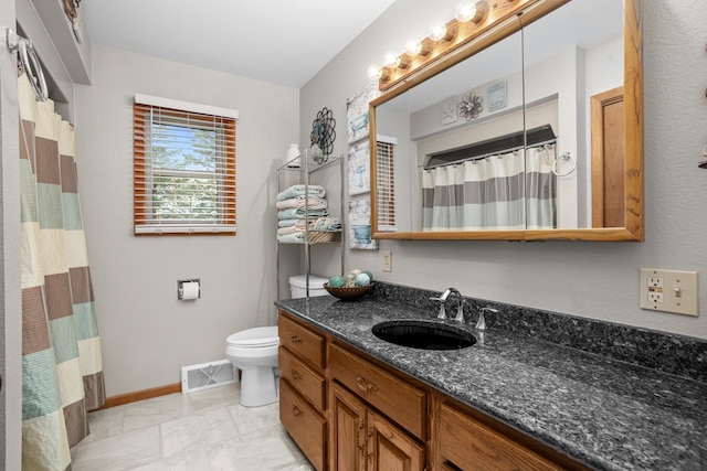 3900 16th St, Minot, ND 58703 - full bathroom featuring toilet, baseboards, vanity, and a shower with shower curtain