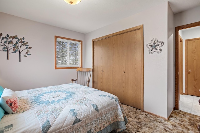 3900 16th St, Minot, ND 58703 - bedroom featuring a closet, carpet flooring, and baseboards