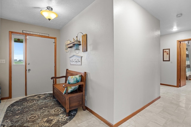 3900 16th St, Minot, ND 58703 - foyer featuring baseboards and a textured ceiling