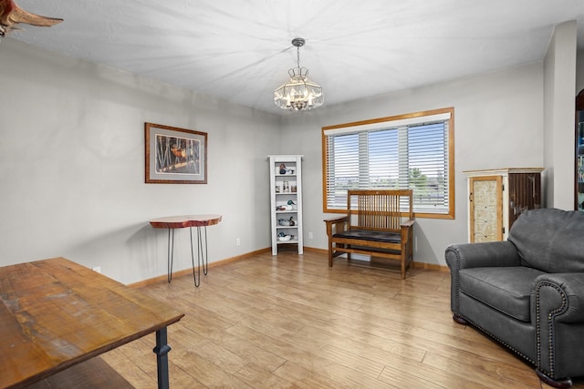 3900 16th St, Minot, ND 58703 - sitting room featuring a chandelier, light wood finished floors, and baseboards