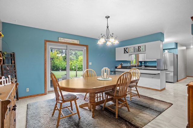 3900 16th St, Minot, ND 58703 - dining room featuring a chandelier and baseboards