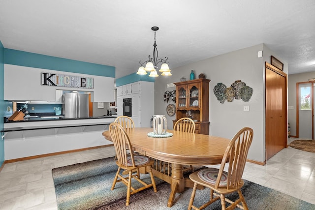 3900 16th St, Minot, ND 58703 - dining space featuring a chandelier and baseboards