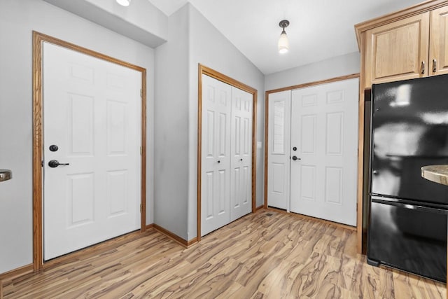 625 34th Ave Unit A, Minot, ND 58701 - foyer with light wood-type flooring and baseboards