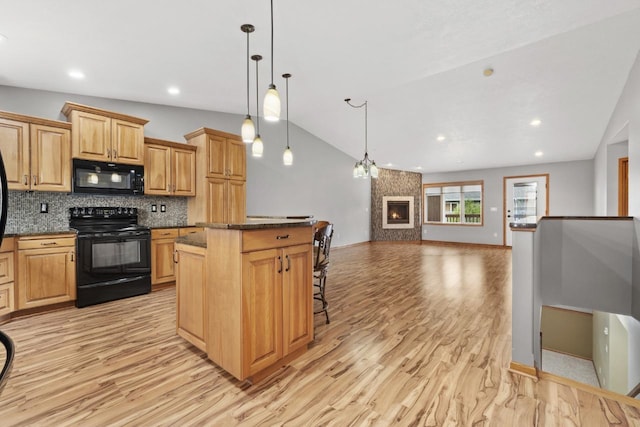 625 34th Ave Unit A, Minot, ND 58701 - kitchen featuring black appliances, open floor plan, light wood finished floors, a center island, and decorative backsplash