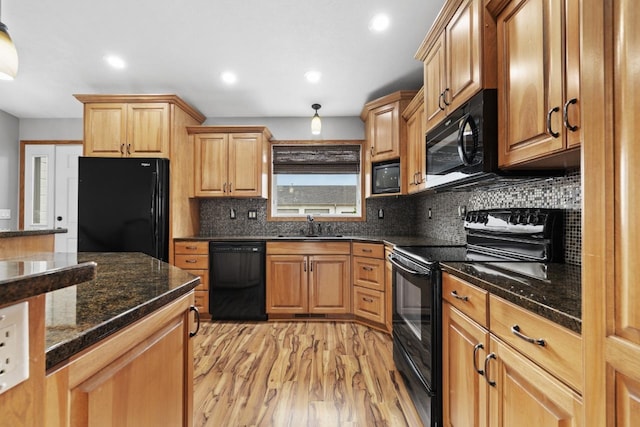625 34th Ave Unit A, Minot, ND 58701 - kitchen featuring black appliances, a sink, light wood-type flooring, decorative backsplash, and recessed lighting