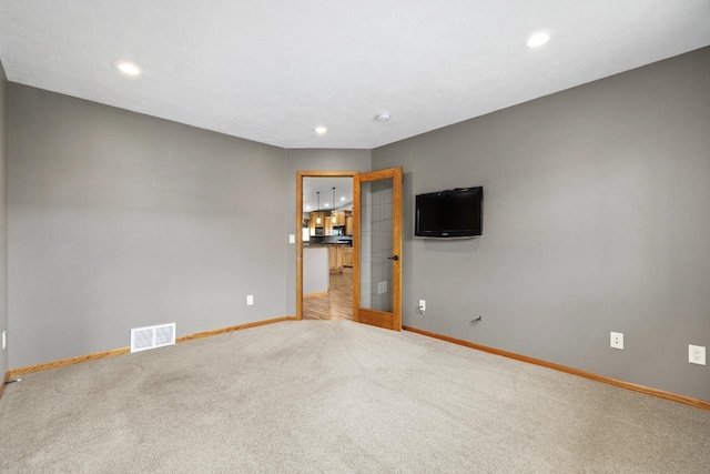 625 34th Ave Unit A, Minot, ND 58701 - empty room featuring baseboards, carpet floors, and recessed lighting
