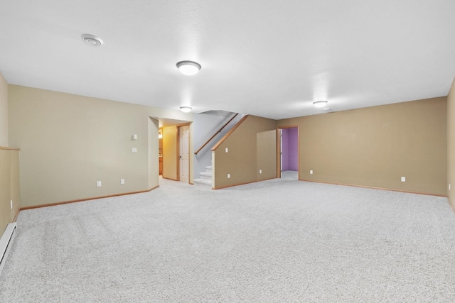 625 34th Ave Unit A, Minot, ND 58701 - finished below grade area with baseboards, light colored carpet, stairway, and a baseboard radiator