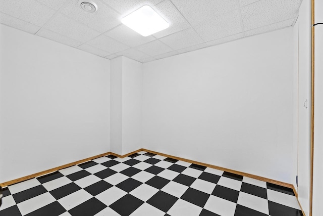 625 34th Ave Unit A, Minot, ND 58701 - empty room featuring light flooring, baseboards, and a paneled ceiling