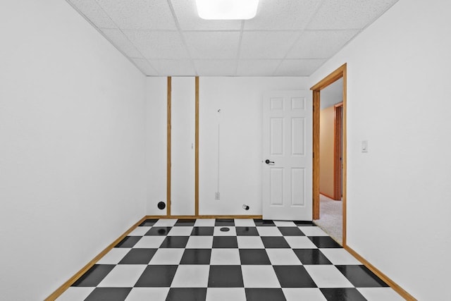 625 34th Ave Unit A, Minot, ND 58701 - unfurnished room featuring tile patterned floors, a paneled ceiling, and baseboards