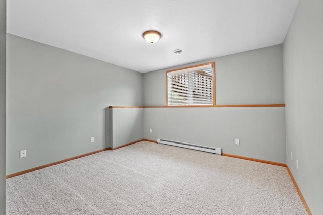 625 34th Ave Unit A, Minot, ND 58701 - empty room with a baseboard heating unit, carpet, and baseboards