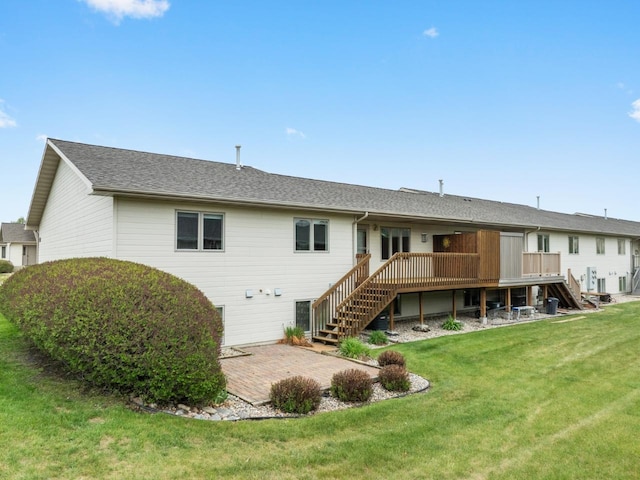 625 34th Ave Unit A, Minot, ND 58701 - back of house with stairs, a wooden deck, a lawn, and a patio area