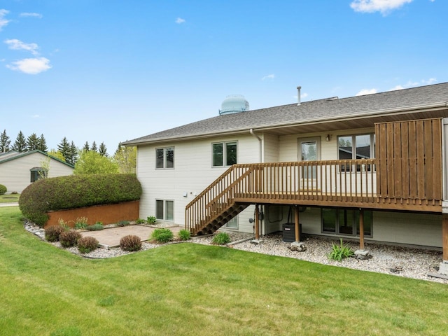 625 34th Ave Unit A, Minot, ND 58701 - rear view of house with a deck, a lawn, a patio area, and stairs