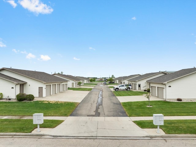 625 34th Ave Unit A, Minot, ND 58701 - view of asphalt street featuring a residential view and community garages