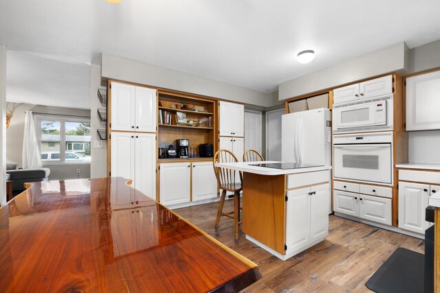 1816 7th St, Minot, ND 58703 - kitchen featuring white appliances, white cabinets, a kitchen island, and open shelves