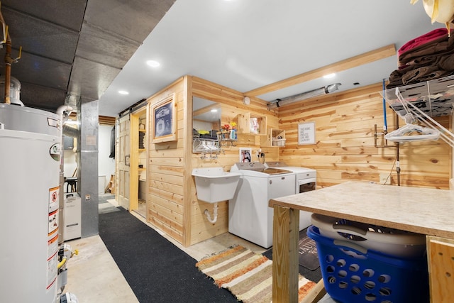 1816 7th St, Minot, ND 58703 - washroom featuring gas water heater, wooden walls, washer and clothes dryer, recessed lighting, and heating unit