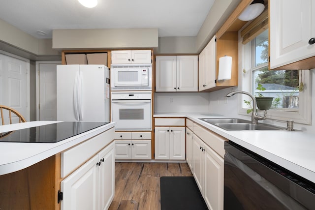 1816 7th St, Minot, ND 58703 - kitchen with black appliances, a sink, light countertops, dark wood finished floors, and white cabinets