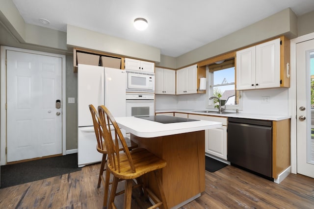 1816 7th St, Minot, ND 58703 - kitchen featuring white appliances, a sink, white cabinetry, and dark wood-style floors