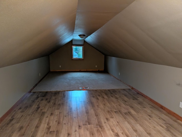 807 NW 8th St, Minot, ND 58703 - bonus room with wood finished floors, lofted ceiling, and baseboards