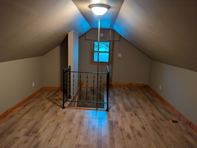 807 NW 8th St, Minot, ND 58703 - bonus room with wood finished floors, lofted ceiling, and baseboards