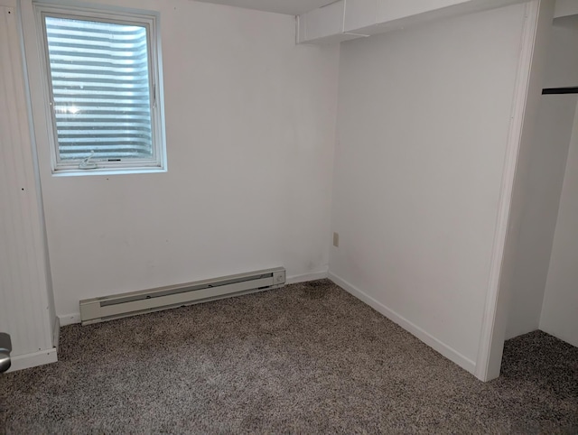 807 NW 8th St, Minot, ND 58703 - carpeted spare room featuring a baseboard heating unit and baseboards