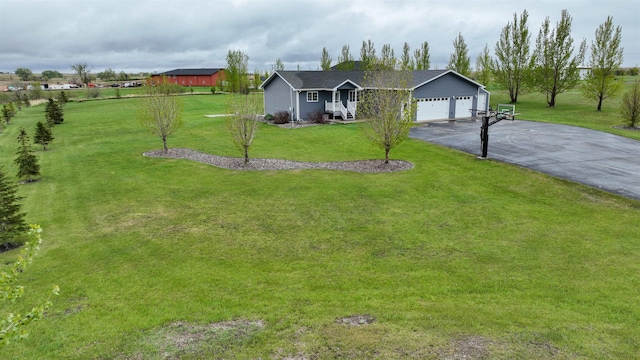 3030 Mustang Trl, Minot, ND 58703 - ranch-style house with driveway, an attached garage, and a front yard