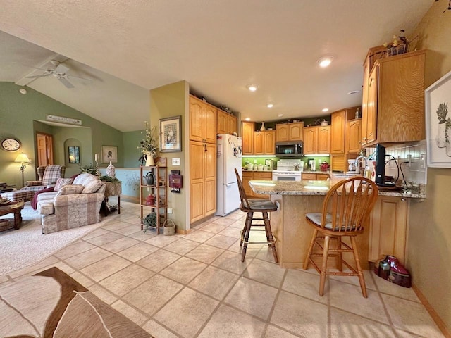 2900 8th St, Minot, ND 58701 - kitchen with white appliances, a peninsula, ceiling fan, open floor plan, and lofted ceiling